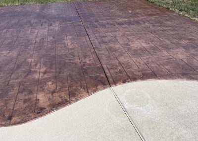 Backyard patio with stamped concrete addition installed by JP Custom Concrete