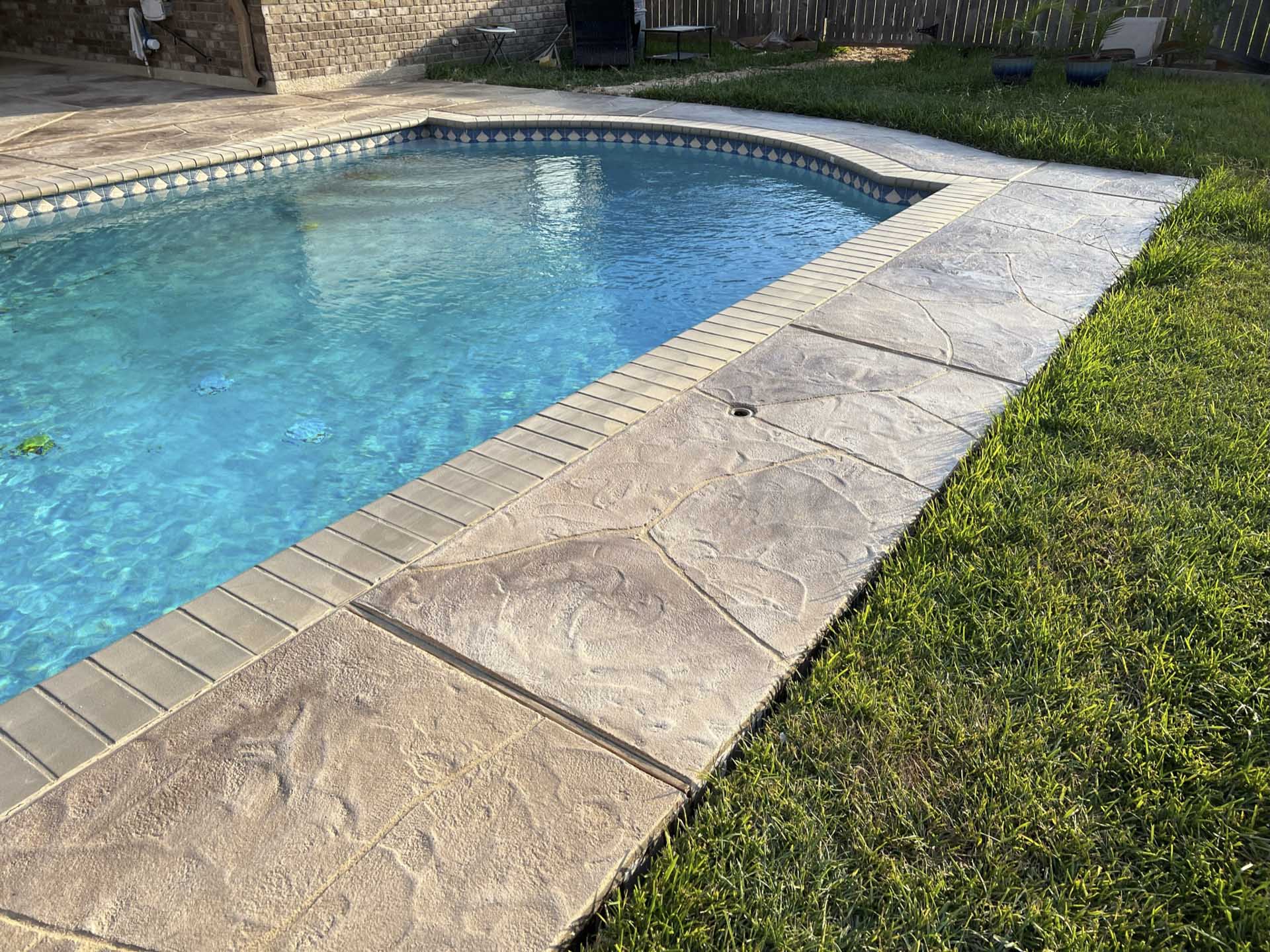 Beautiful stamped concrete patio and pool deck in Friendswood, TX by expert concrete contractors JP Custom Concrete