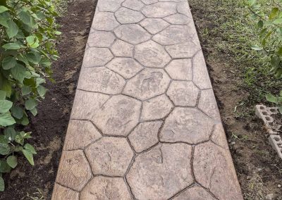 Stamped concrete sidewalk installed by expert concrete company JP Custom Concrete in Friendswood, TX