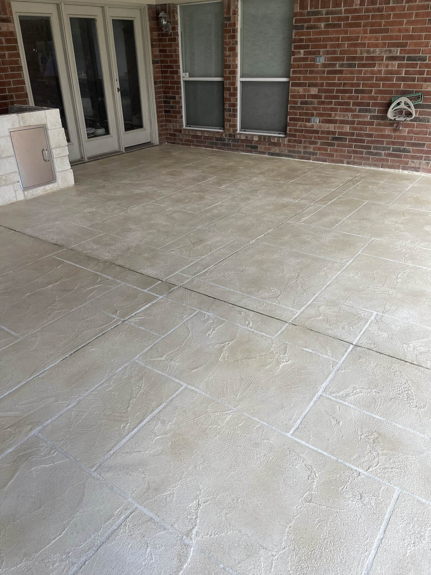 New backyard stamped concrete patio installed by JP Custom Concrete in Friendswood, TX